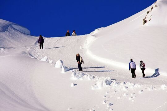 Ascent of a winter hiking trail with hikers