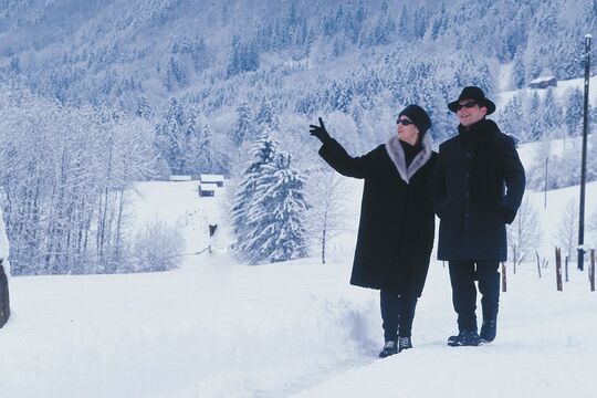 A couple on a winter hike on a narrow path in the valley on a cloudy winter's day