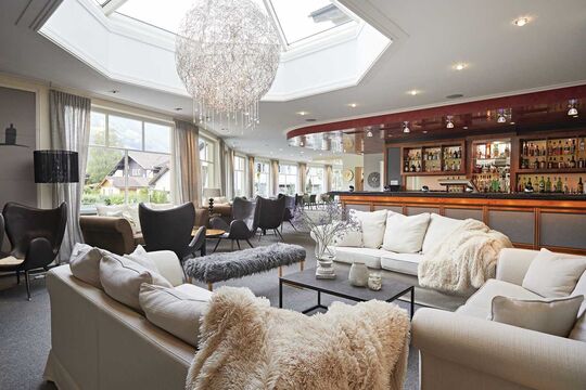 Hotel lobby with lounge furniture, sofas and the hotel bar in the background