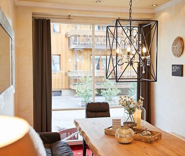 A seating area in the lobby of the hotel with the regulars' table and chandelier above it